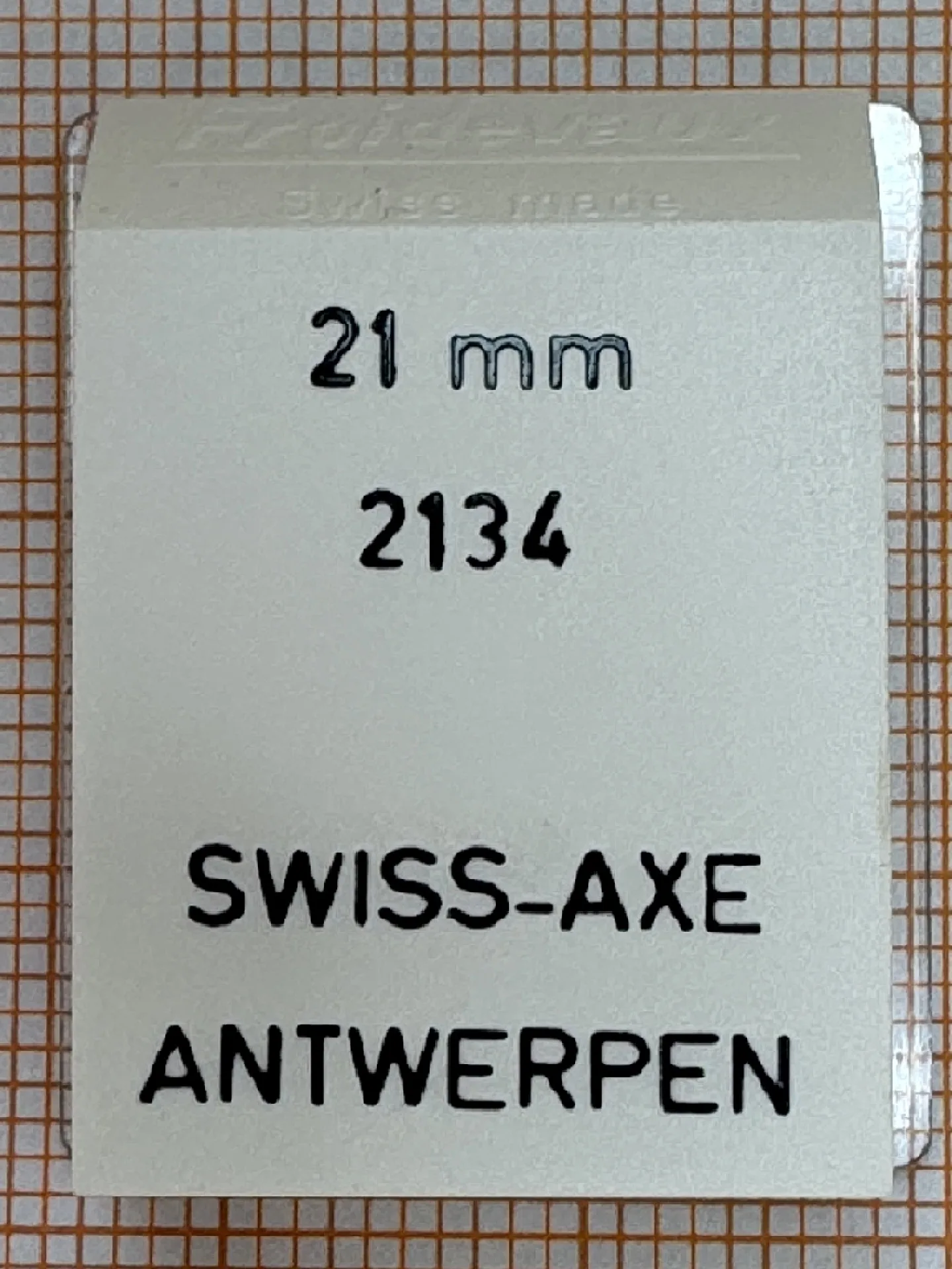 Swiss-Axe Uhrenteil 21mm Verpackung eines Swiss-Axe Uhrenteils mit der Aufschrift 21 mm und 2134.