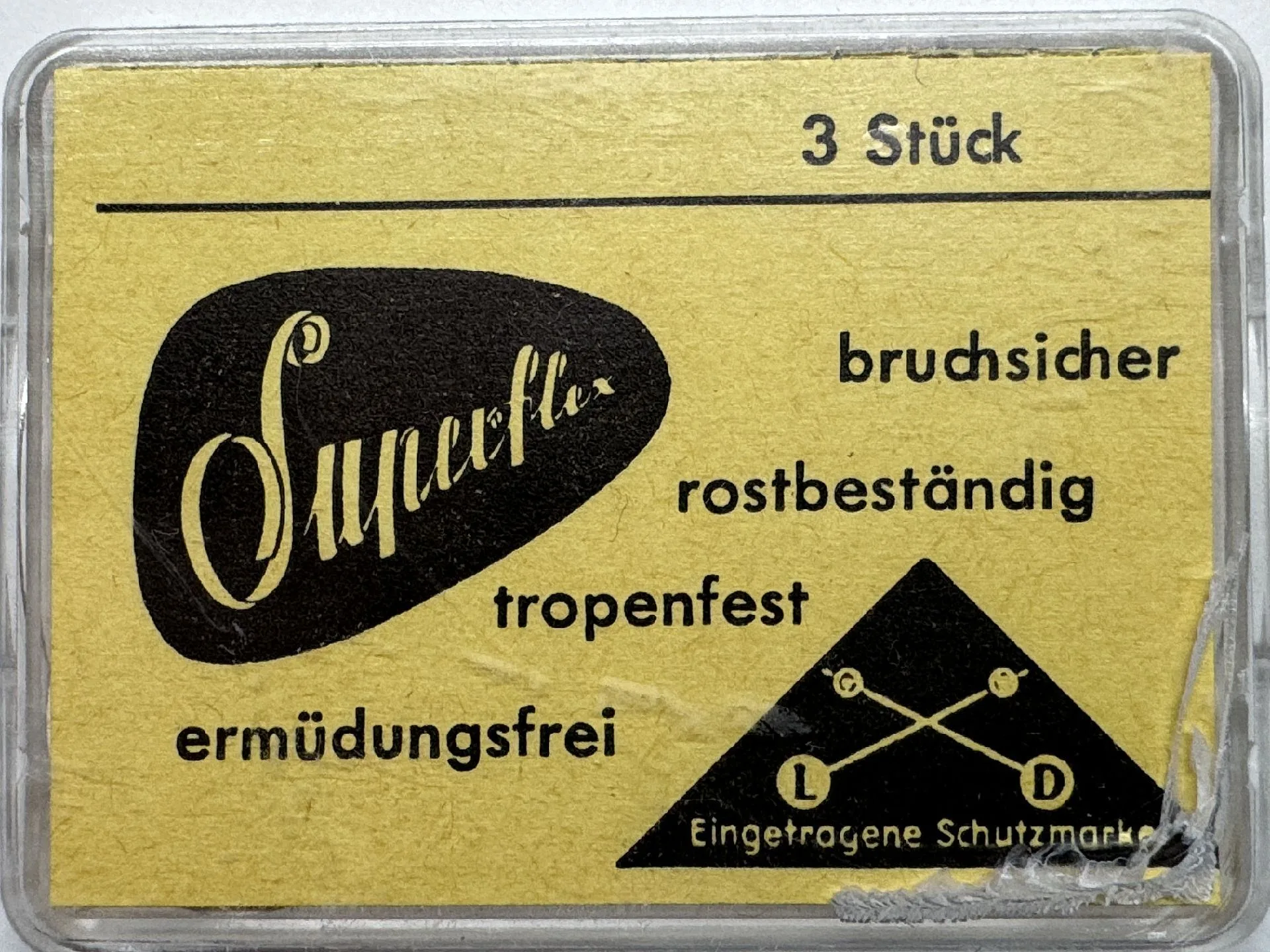 Verpackung mit drei Superflex Federstegen für Uhren, gelbes Etikett mit schwarzer Aufschrift.