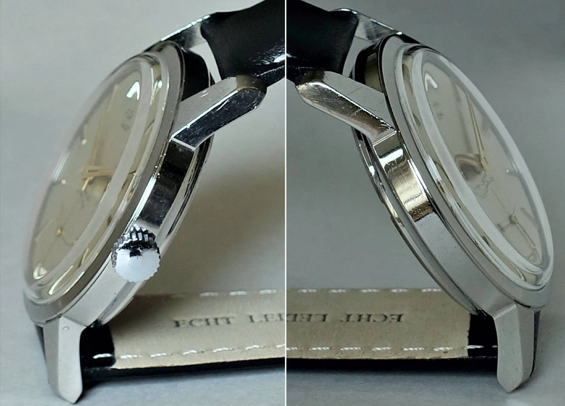 Silberfarbene Armbanduhr mit hellem Zifferblatt und schwarzem Lederarmband, seitlich fotografiert.