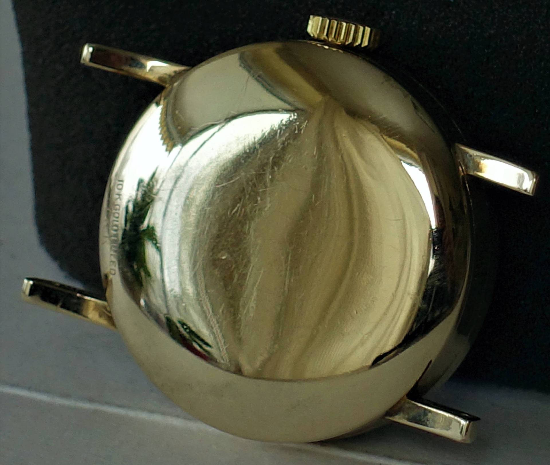 Goldfarbenes Uhrengehäuse mit Krone und Halterungen