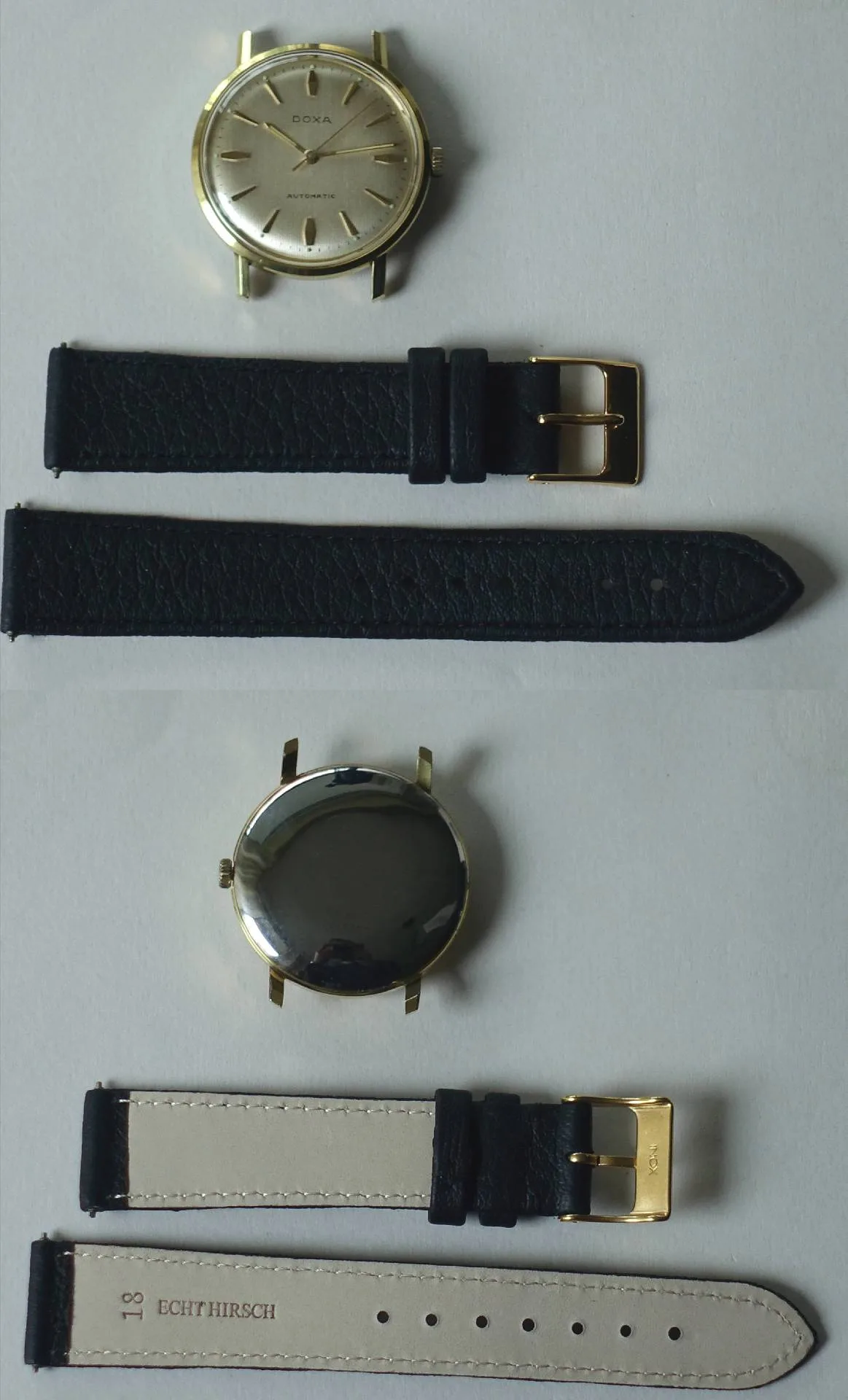 Goldfarbene Doxa Armbanduhr mit hellem Zifferblatt und schwarzem Lederarmband.