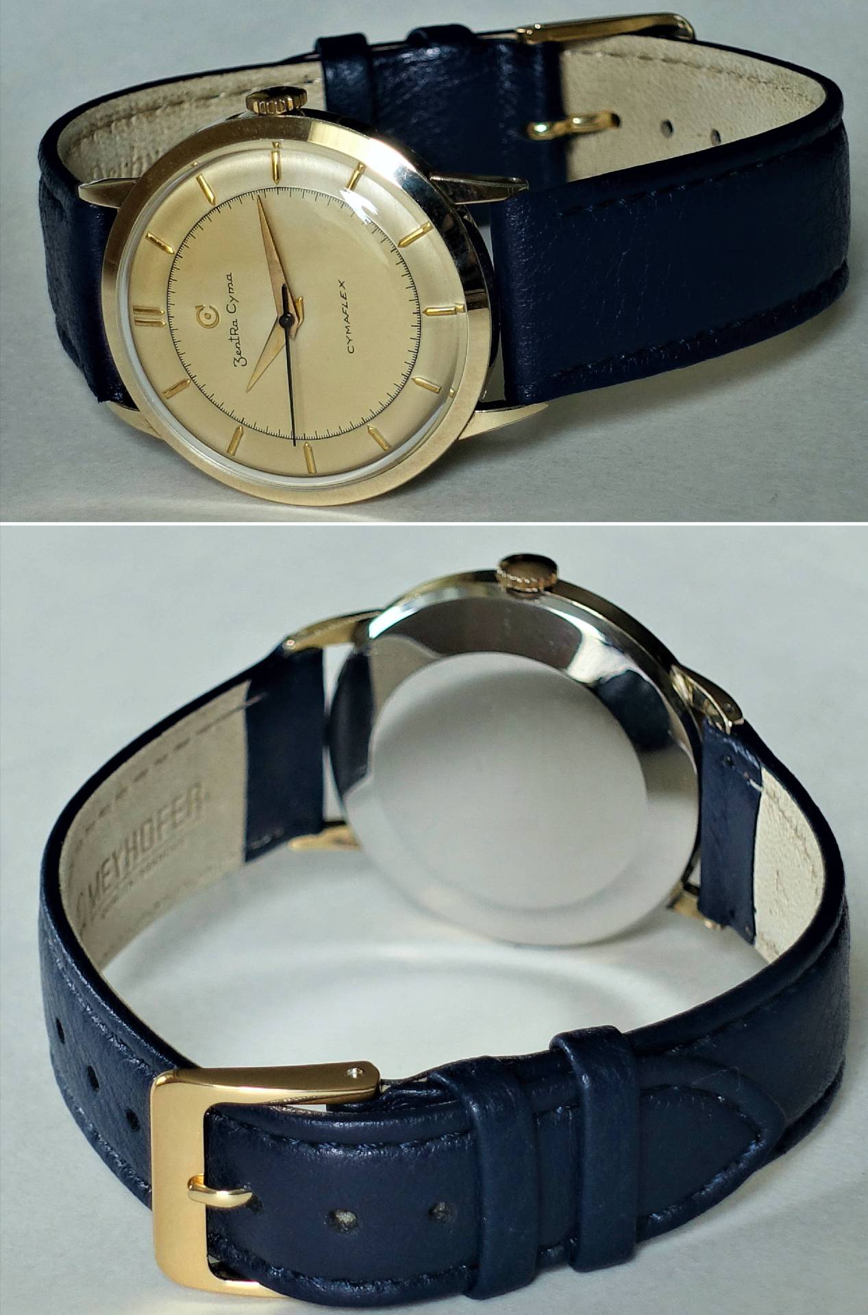 Goldfarbene Armbanduhr mit hellem Zifferblatt und dunkelblauem Lederarmband.