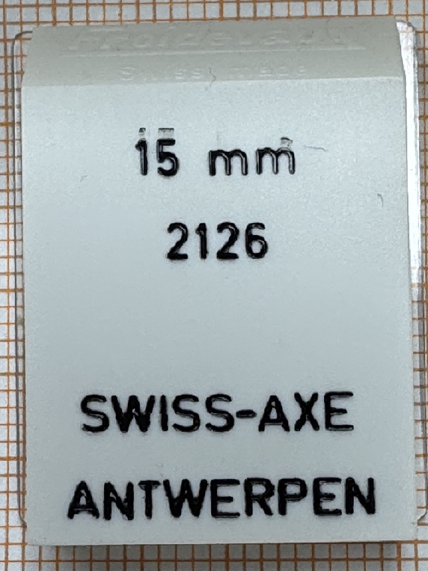 Verpackung für einen 15 Millimeter Federsteg für Uhren, mit Aufdruck Swiss-Axe Antwerpen.