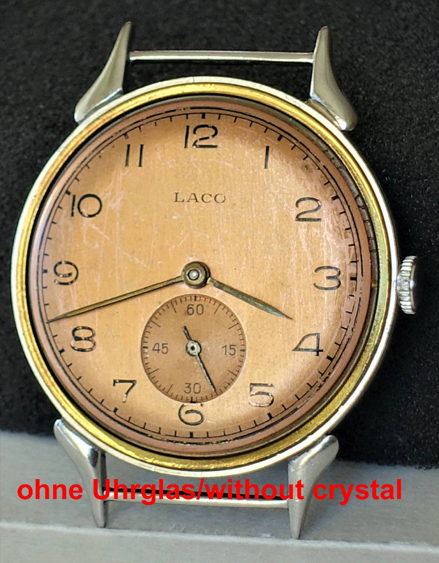 Silberfarbene Armbanduhr mit kupferfarbenem Zifferblatt und kleiner Sekunde, ohne Uhrglas.