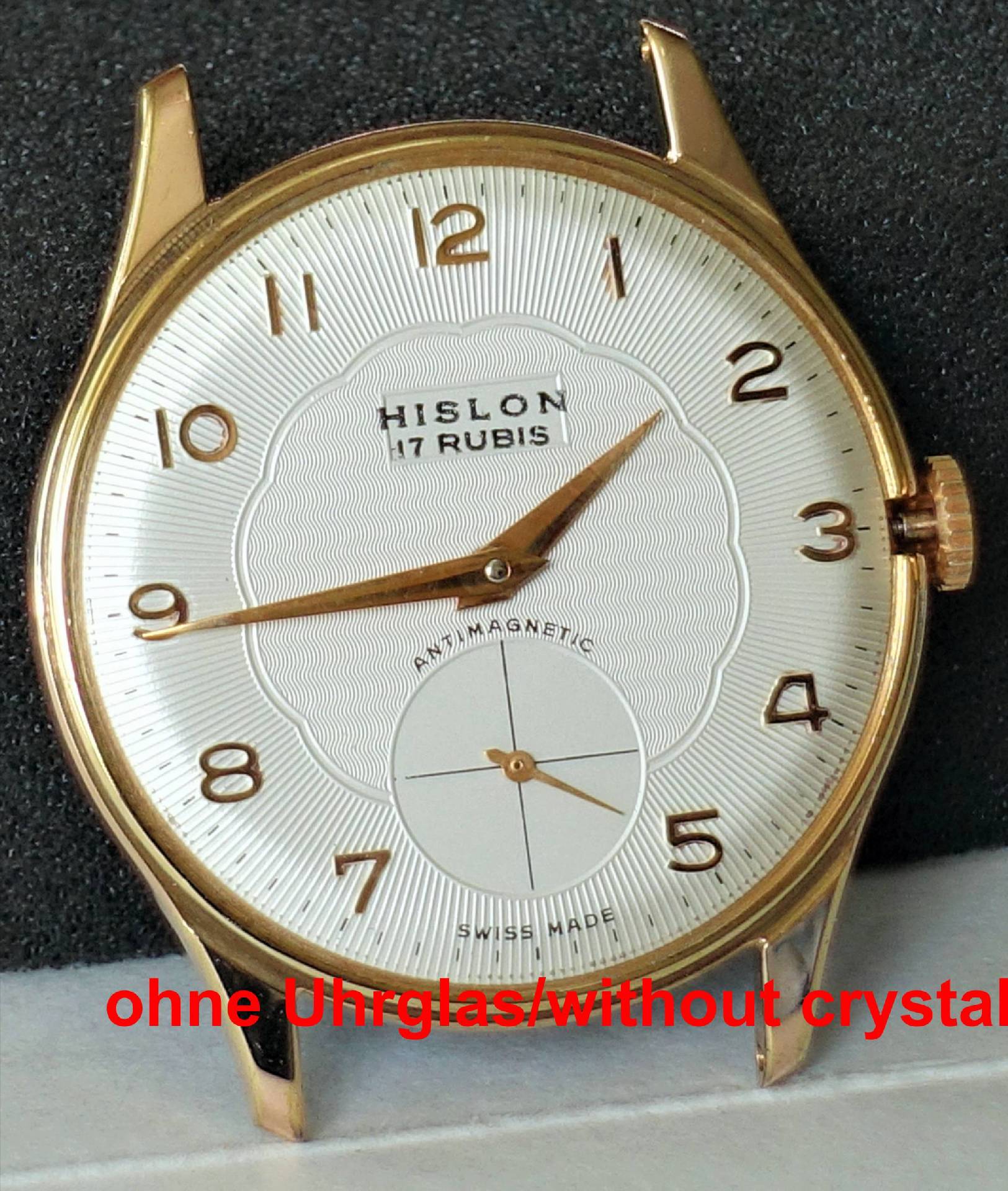 Goldfarbene Armbanduhr mit weißem Zifferblatt und arabischen Zahlen, ohne Uhrglas.