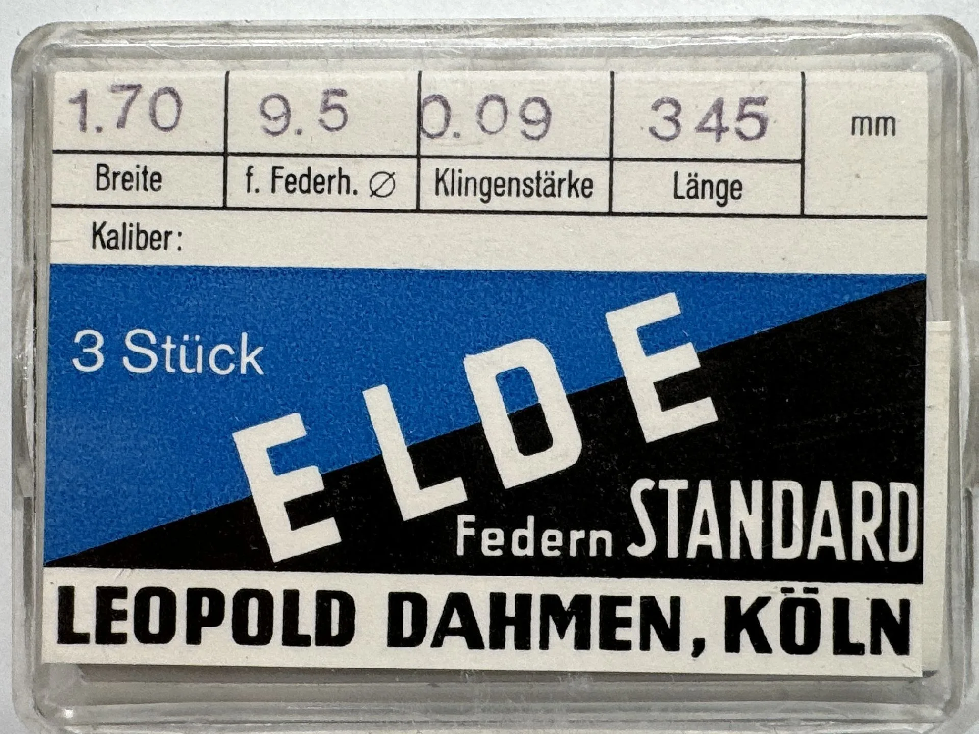 Set mit drei Uhrmacher Federn in transparenter Kunststoffbox mit blau-weißem Etikett.