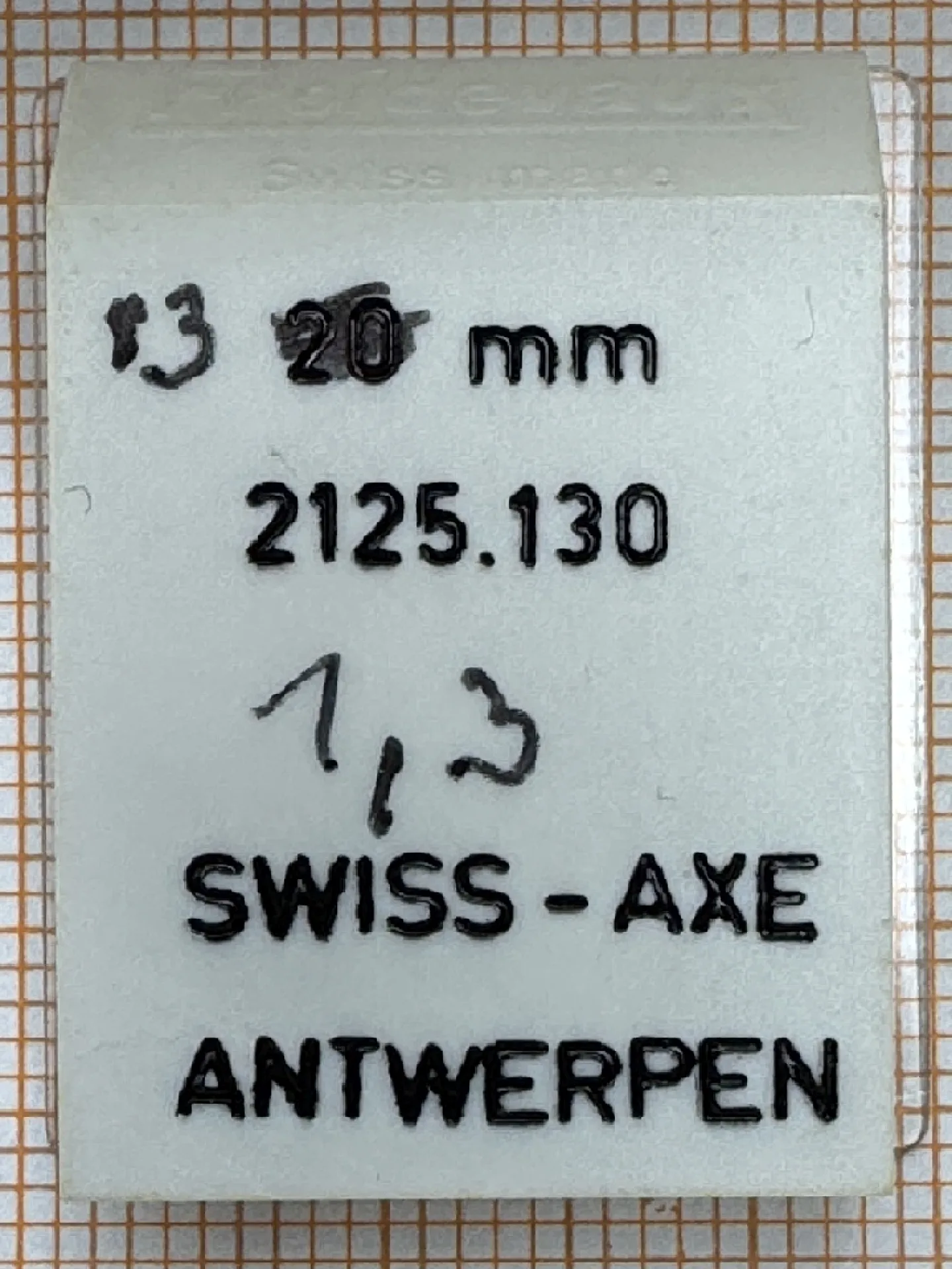 Swiss-Axe Uhrenteil Verpackung eines Swiss-Axe Uhrenteils mit der Aufschrift 2125.130 aus Antwerpen.