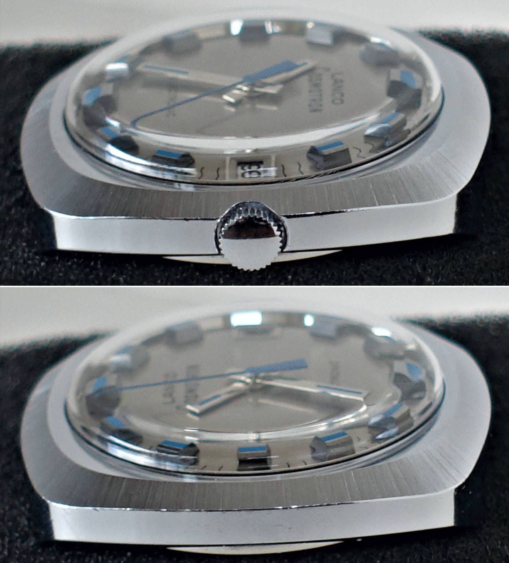 Silberfarbenes Gehäuse einer Armbanduhr mit silbernem Zifferblatt und blauen Zeigern.
