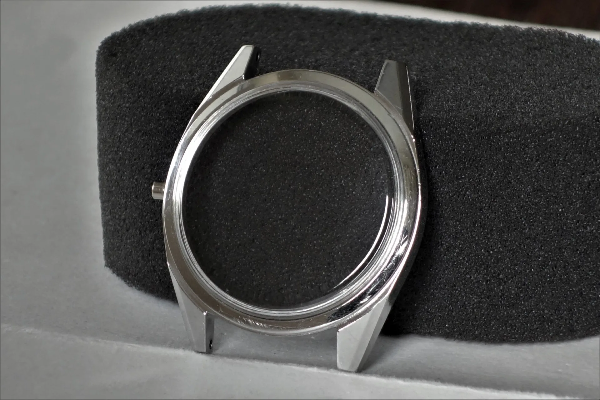 Silberfarbenes Gehäuse für Armbanduhren ohne Uhrwerk und Armband.