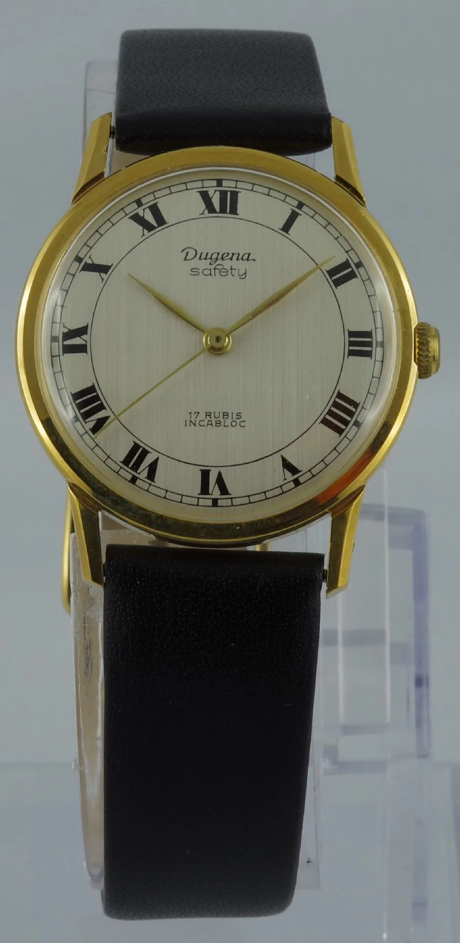 Dugena Armbanduhr goldfarben Klassische Armbanduhr mit goldfarbenem Gehäuse, hellem Zifferblatt und schwarzem Armband.