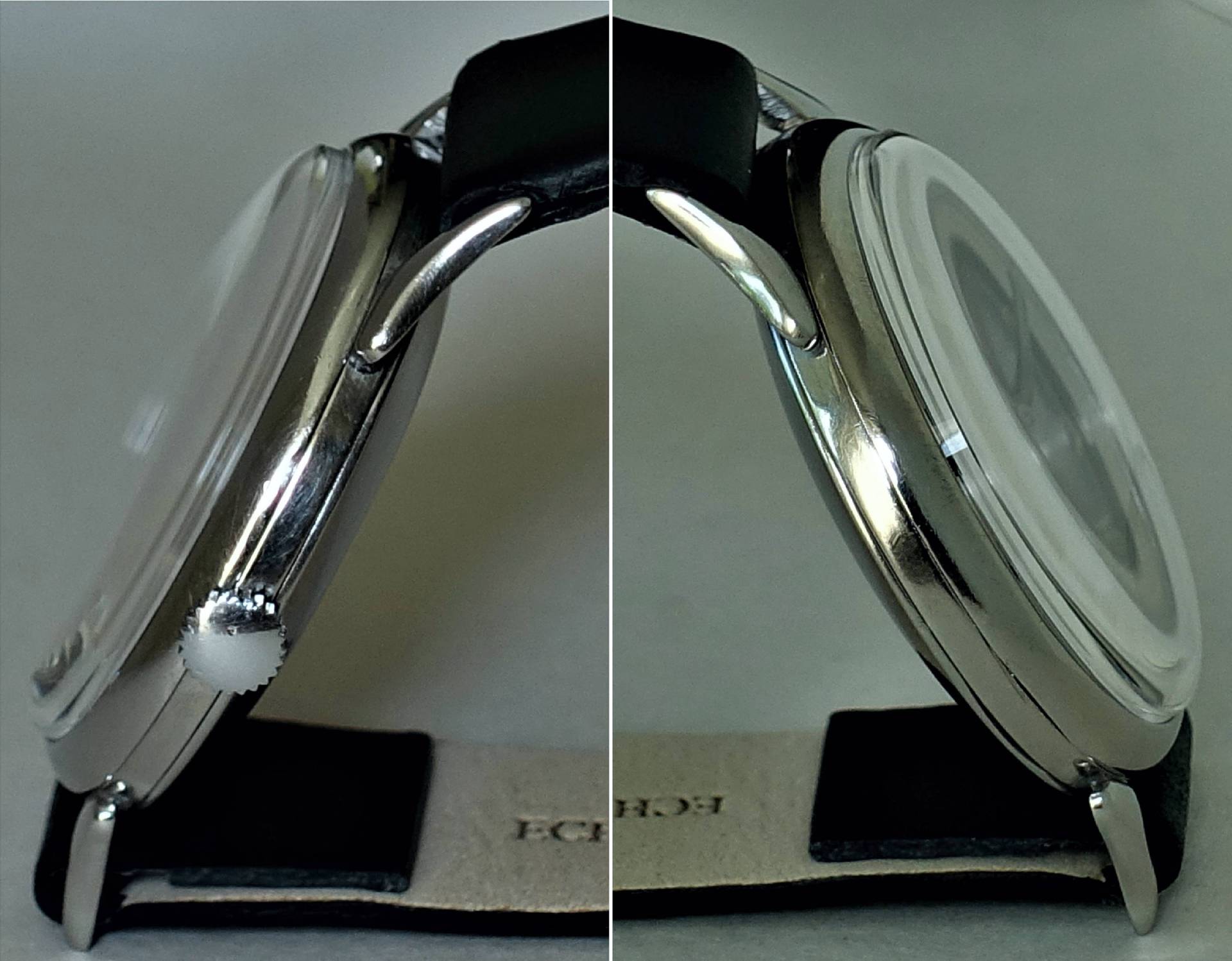 Silberfarbene Armbanduhr mit schwarzem Armband, seitliche Ansicht.