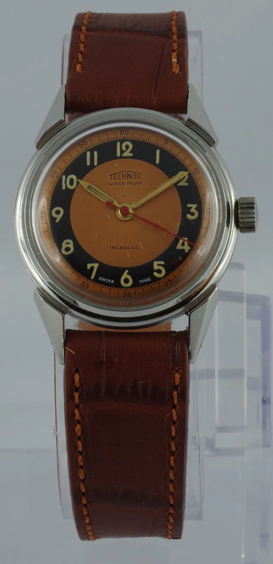 Technos Armbanduhr braunes Leder Analoge Armbanduhr mit braunem Lederarmband und zweifarbigem Zifferblatt in Orange und Schwarz.
