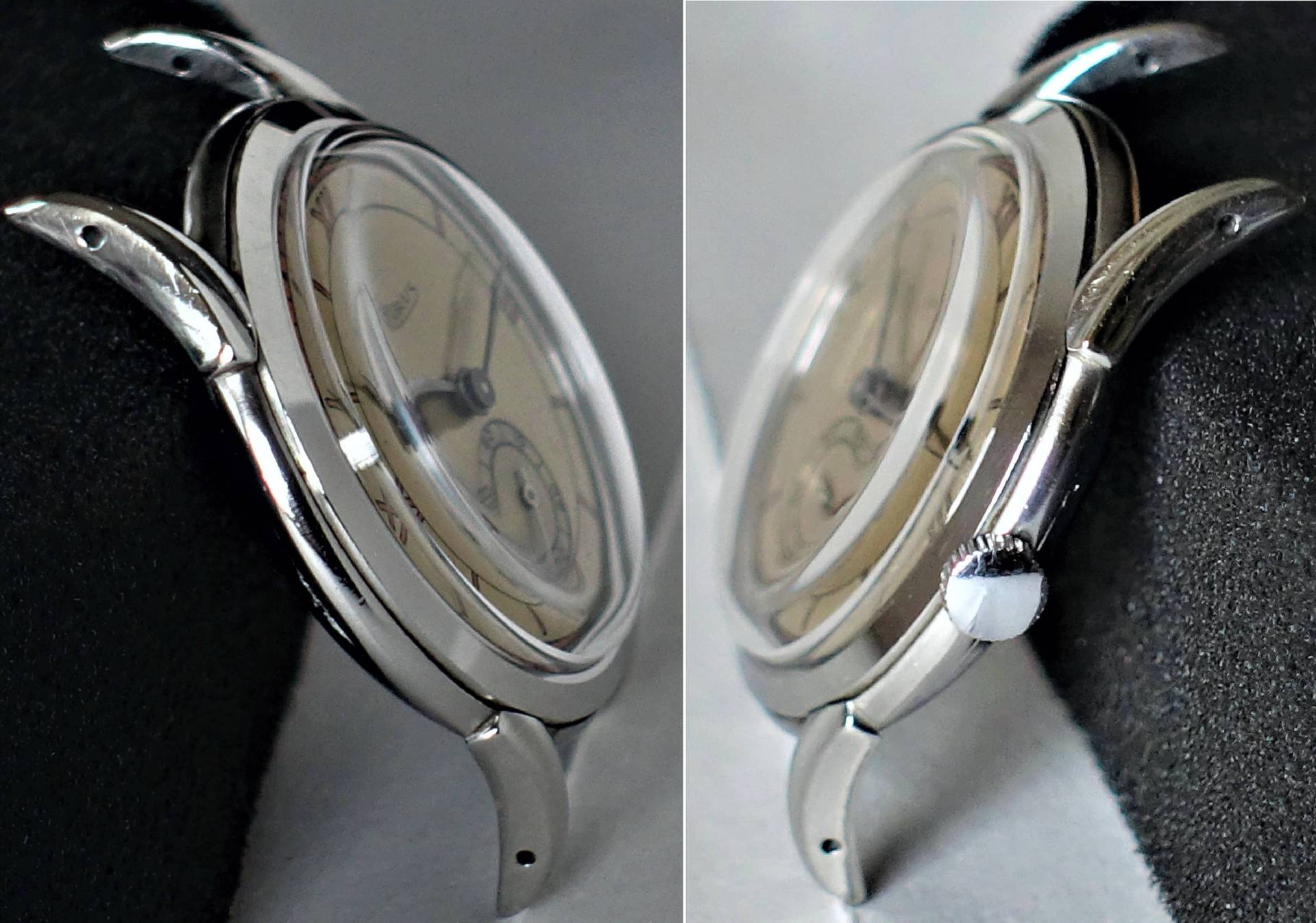 Die Uhr besitzt ein beiges Zifferblatt und ein silberfarbenes Gehäuse mit markanten Bandanstößen.