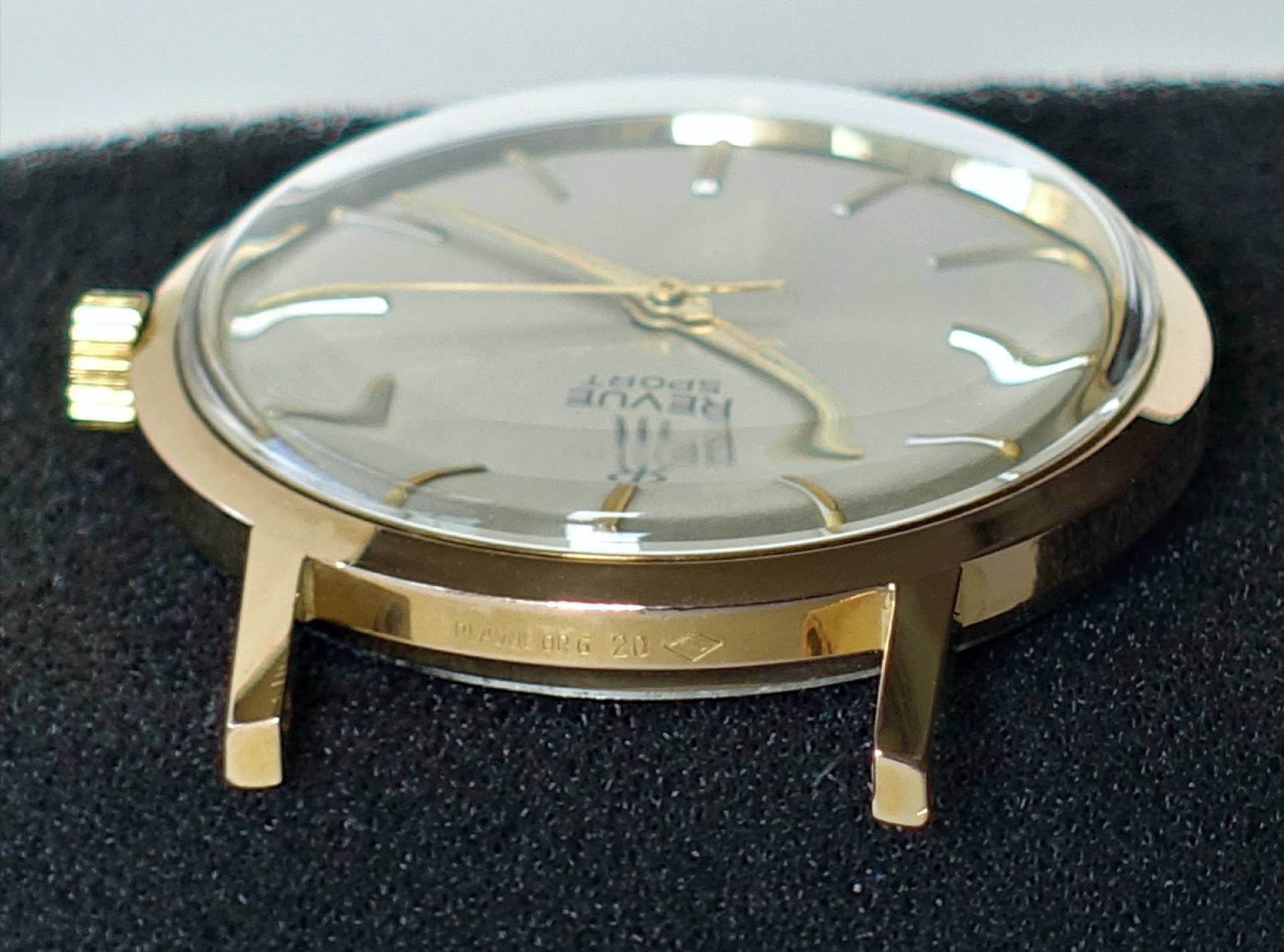 Goldfarbene Armbanduhr mit hellem Zifferblatt und goldenen Zeigern.