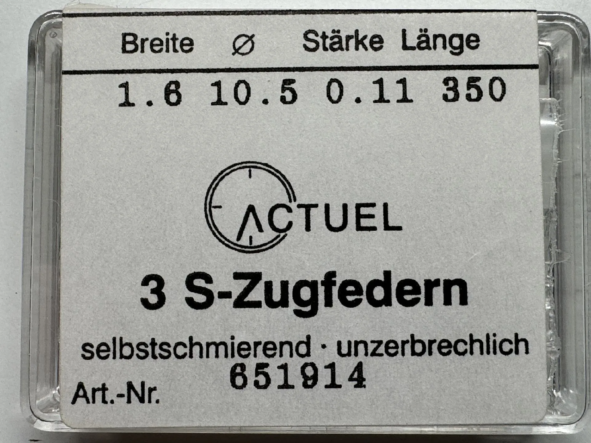Zugfeder Set Verpackung mit drei Zugfedern für Uhren, beschriftet mit technischen Angaben.