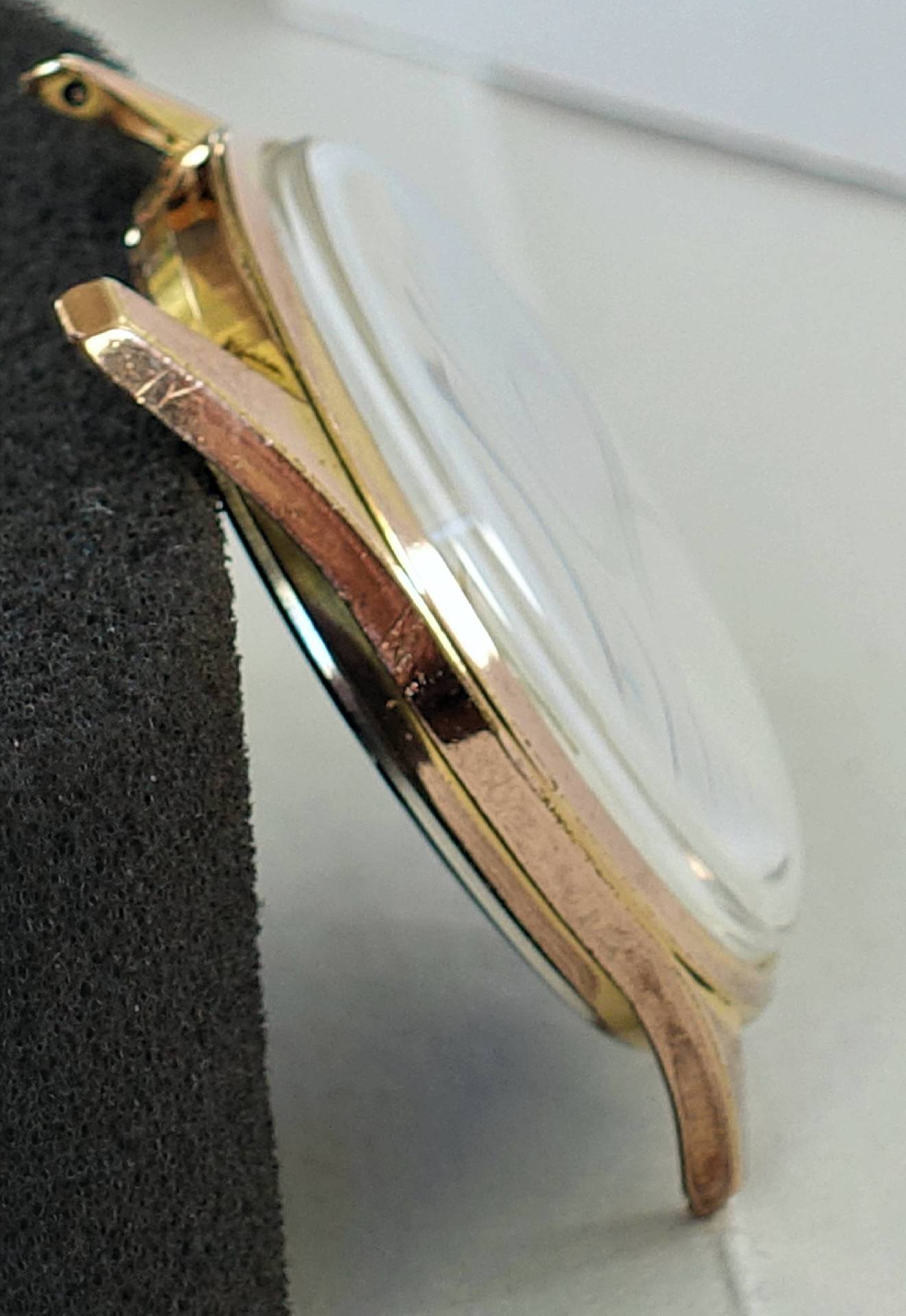 Goldfarbenes Gehäuse für Armbanduhren mit montiertem Uhrglas.