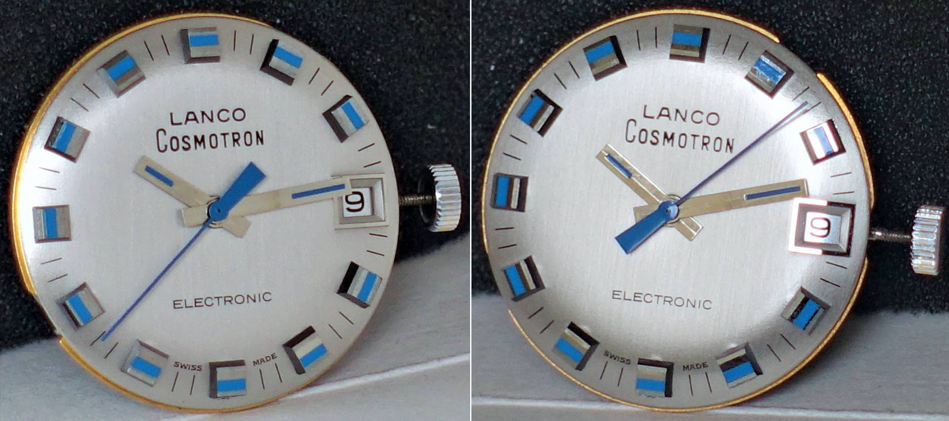 Silberfarbenes Zifferblatt einer Lanco Cosmotron Uhr mit blauen und silbernen Indizes, goldfarbenen und blauen Zeigern sowie Datumsanzeige.