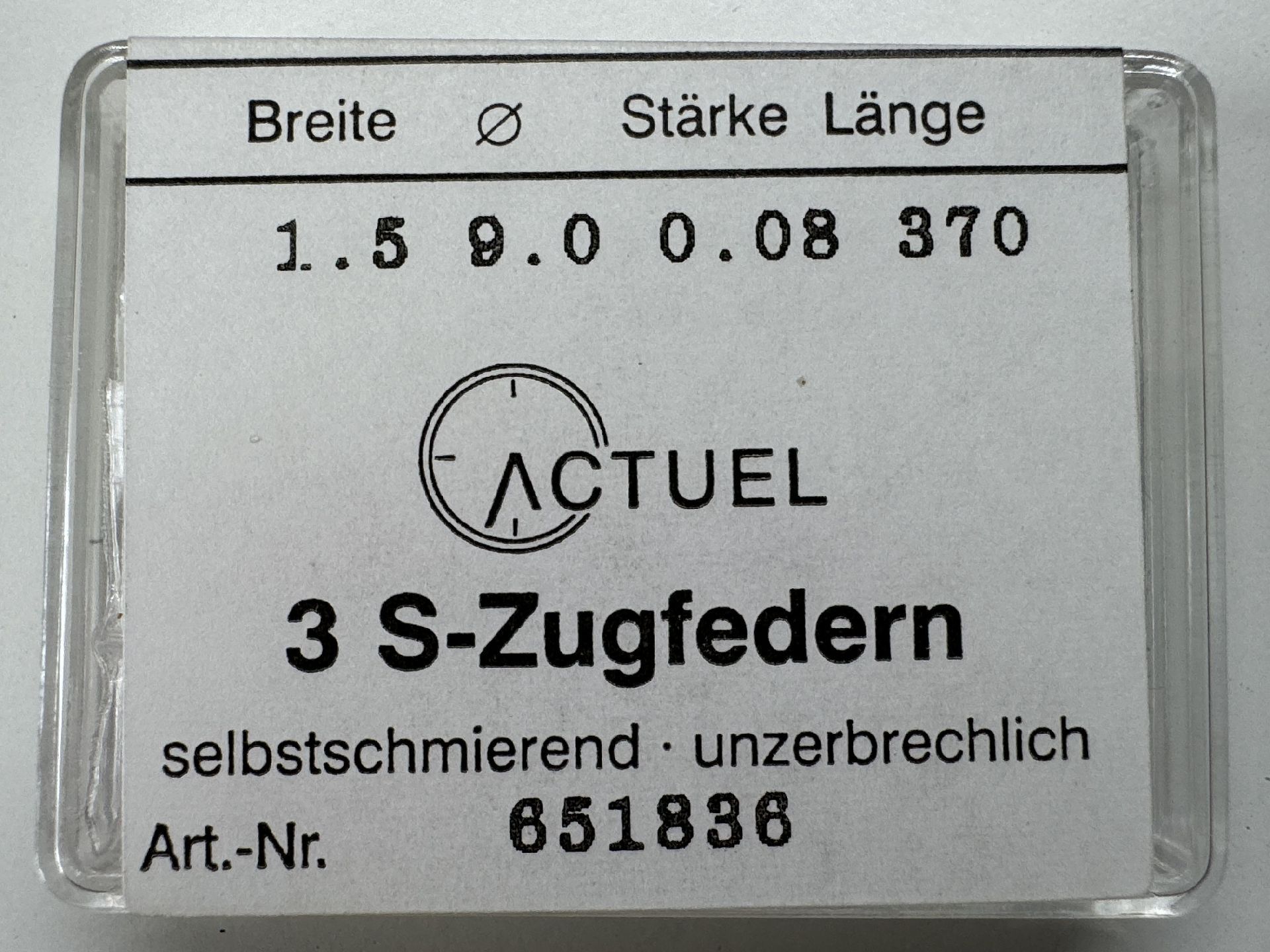 Set mit drei silberfarbenen Zugfedern für Uhren in transparenter Verpackung.