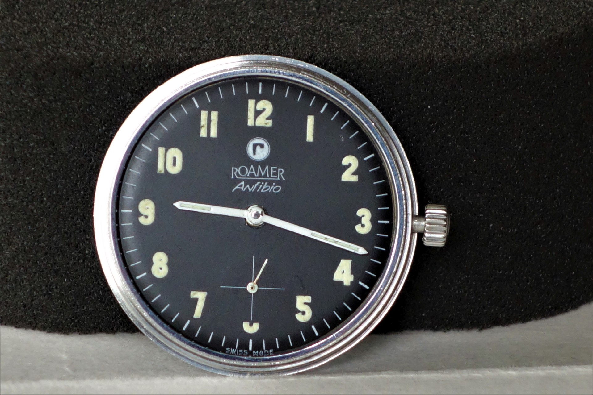 Schwarzes Uhrwerk mit silberfarbenem Rand und Leuchtziffern, Marke Roamer Anfibio.