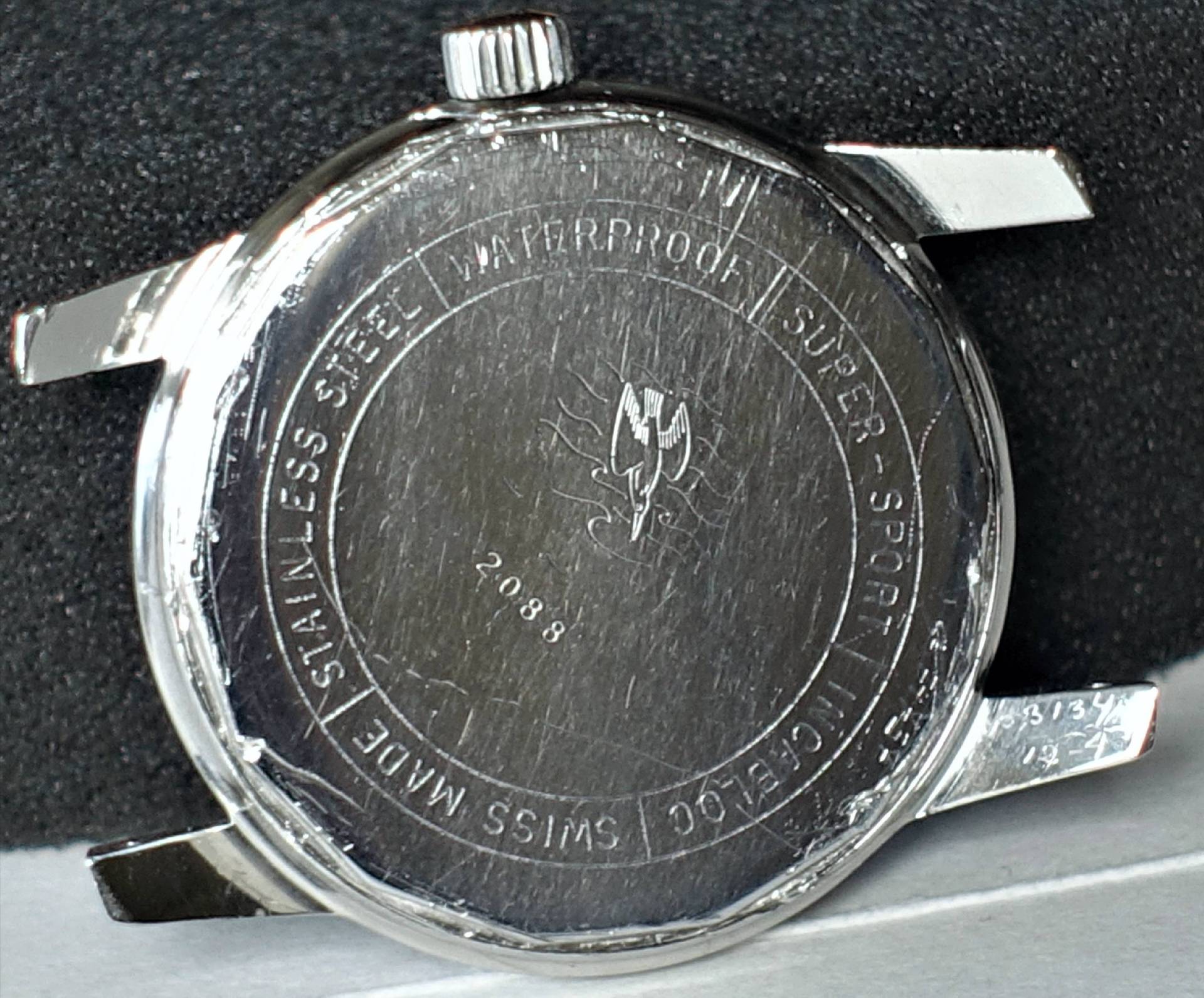 Detailaufnahme der Rückseite einer modernen Uhr aus Edelstahl, wasserdicht, mit dem Hinweis auf Super Sport und Schweizer Herstellung.