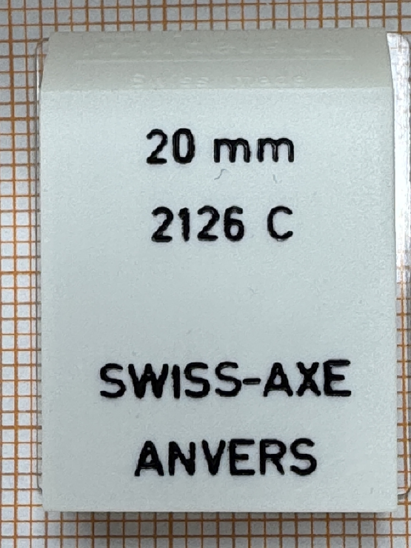 Weißes Uhrmacherwerkzeug mit schwarzer Beschriftung für Uhrenreparatur.