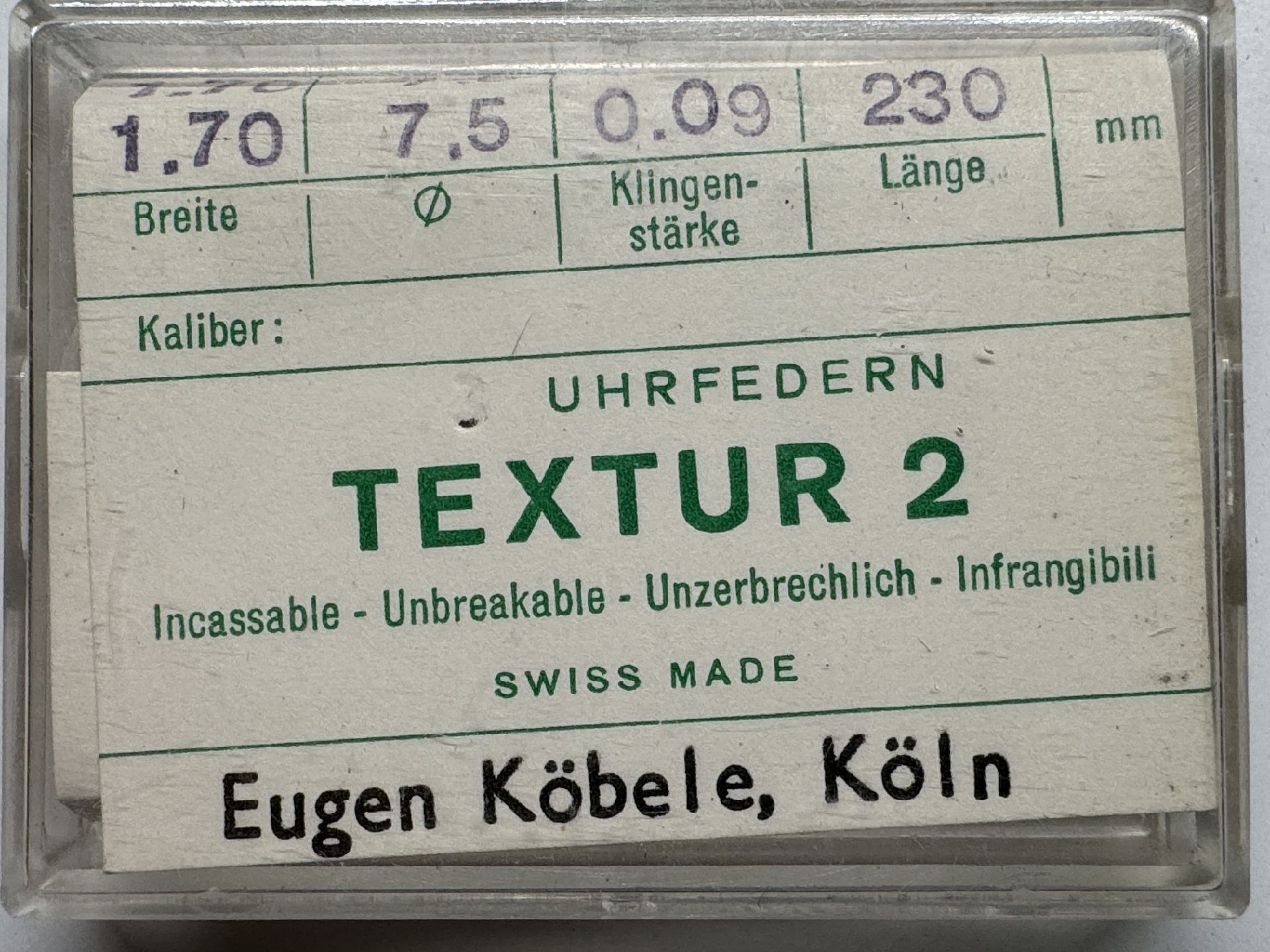 Verpackte Ersatz-Uhrfeder Textur 2 für Armbanduhren, mit technischen Angaben auf dem Etikett.