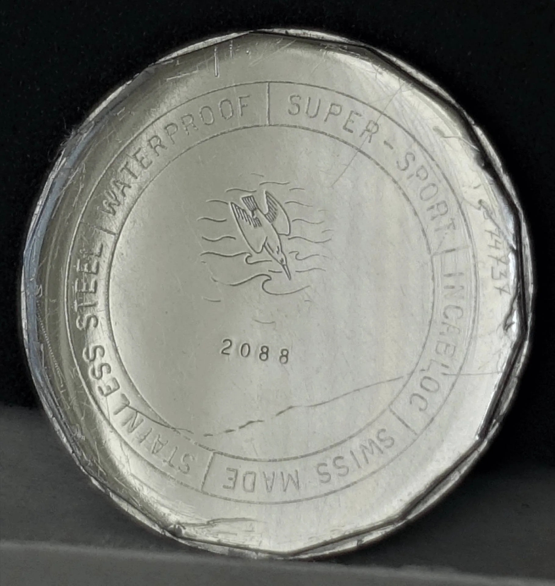 Uhrendesign aus Edelstahl mit Aufschrift über Wasserfestigkeit und Schweizer Herstellung