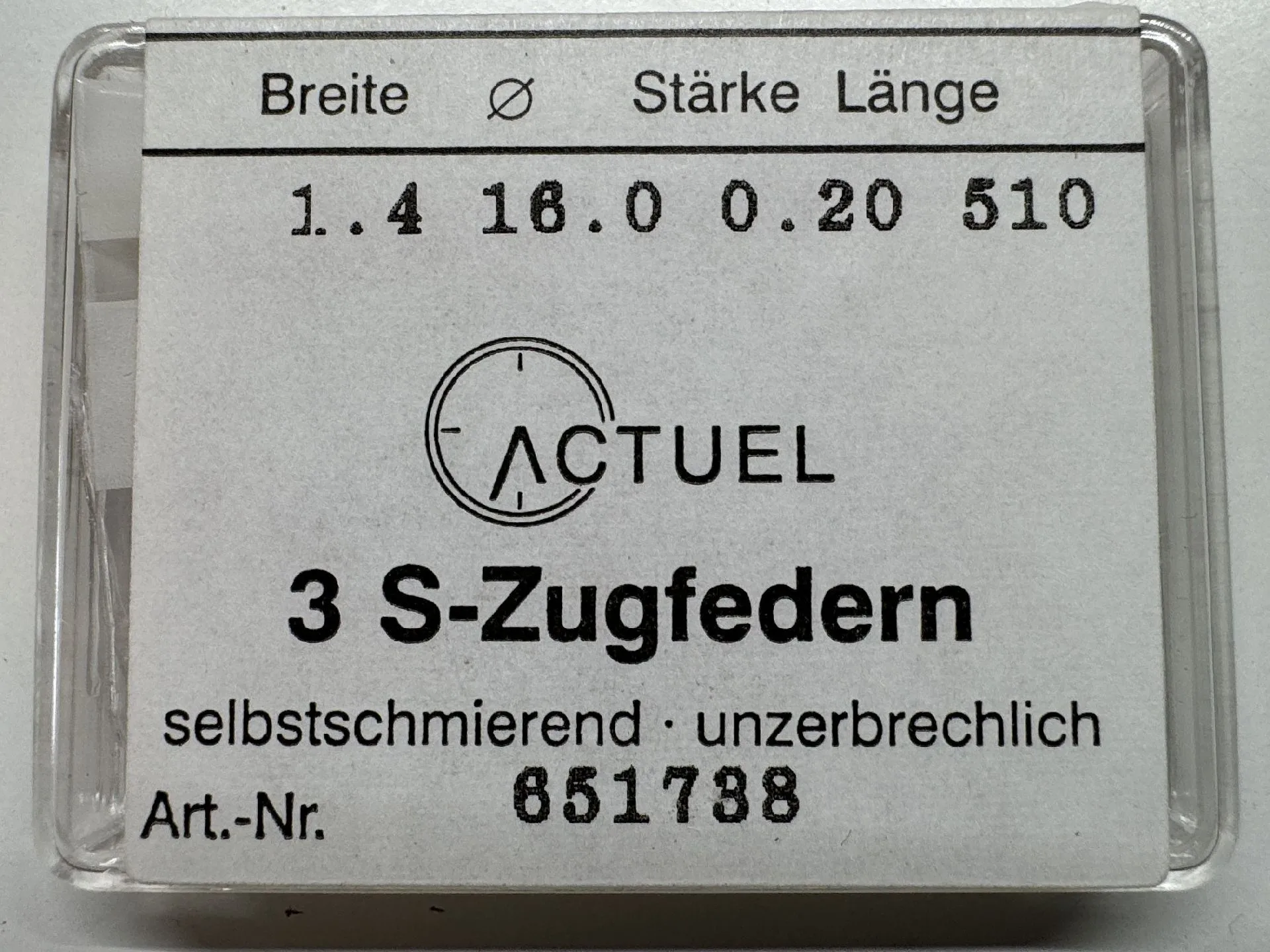 Zugfeder Set Uhrwerk Set mit drei silberfarbenen Zugfedern für Uhrwerke in transparenter Verpackung.