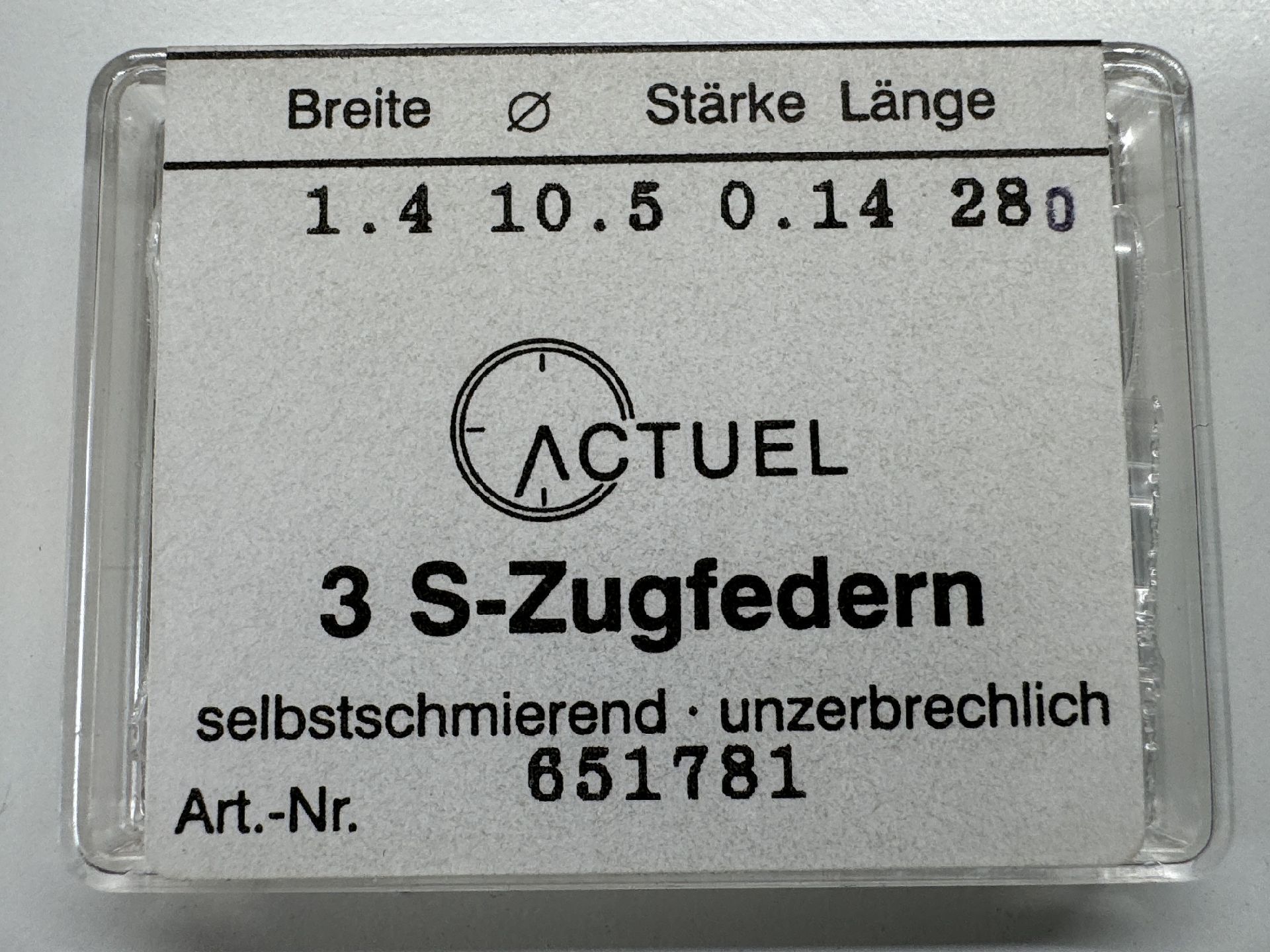 Set mit drei silberfarbenen Zugfedern für Uhren in transparenter Verpackung.