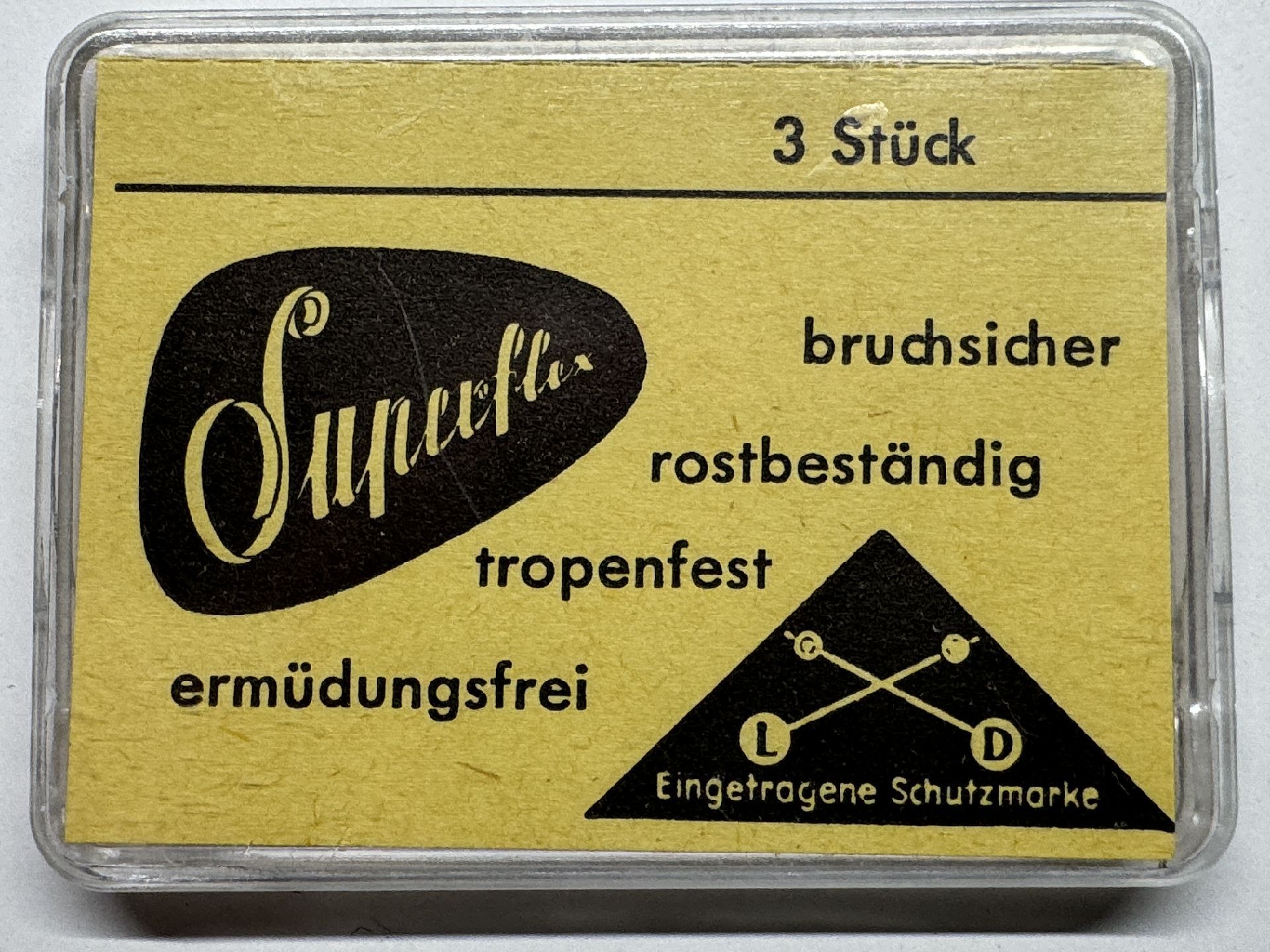 Gelbe Verpackung mit drei Superflex Federstegen für Uhren.