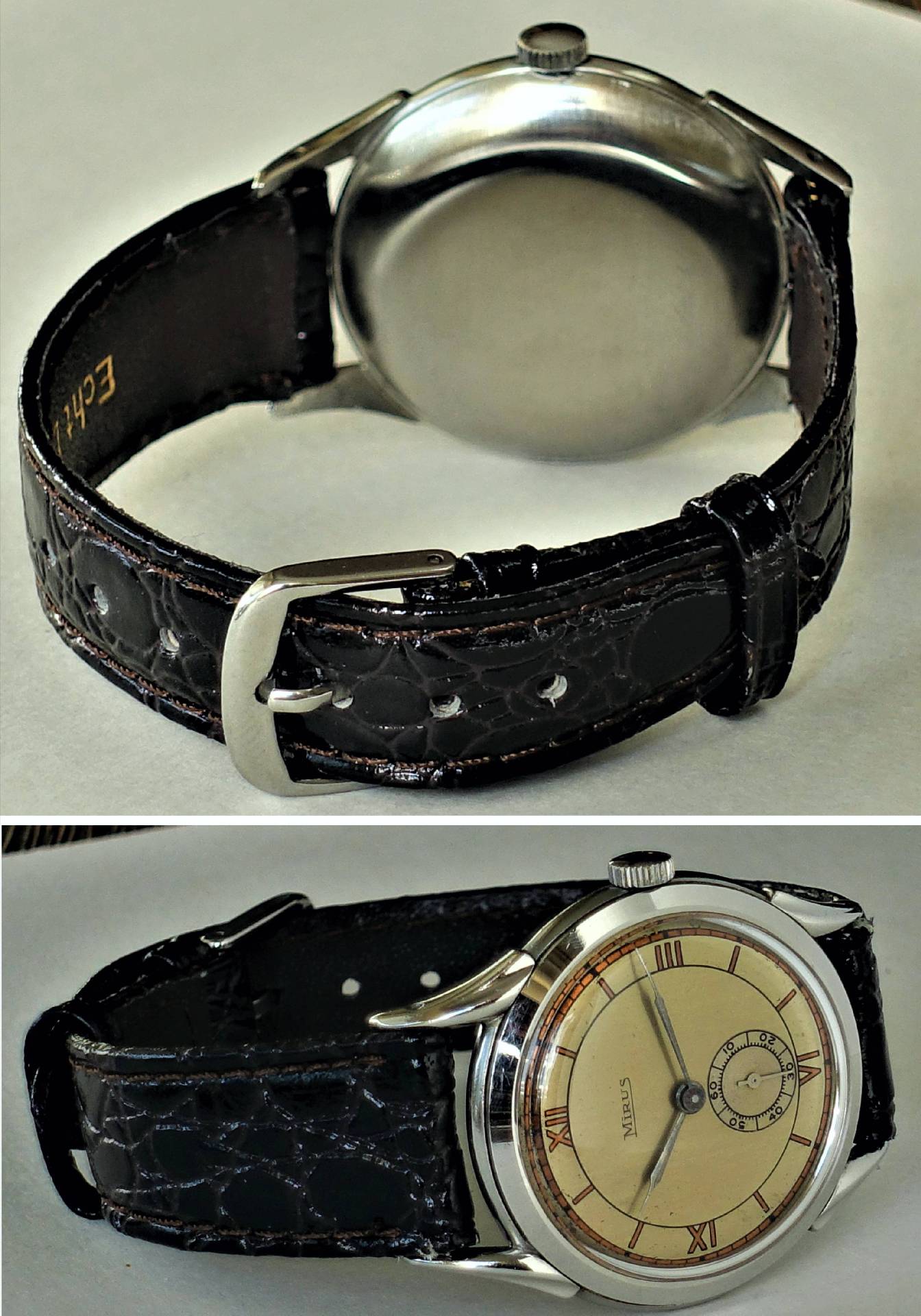 Eine klassische Armbanduhr mit cremefarbenem Zifferblatt, braunem Armband und silberfarbenem Gehäuse.