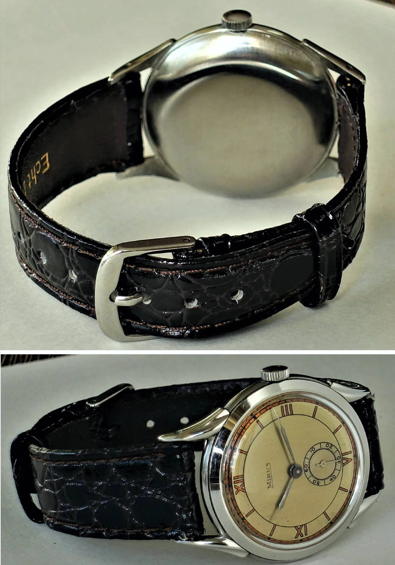 Eine klassische Armbanduhr mit cremefarbenem Zifferblatt, braunem Armband und silberfarbenem Gehäuse.