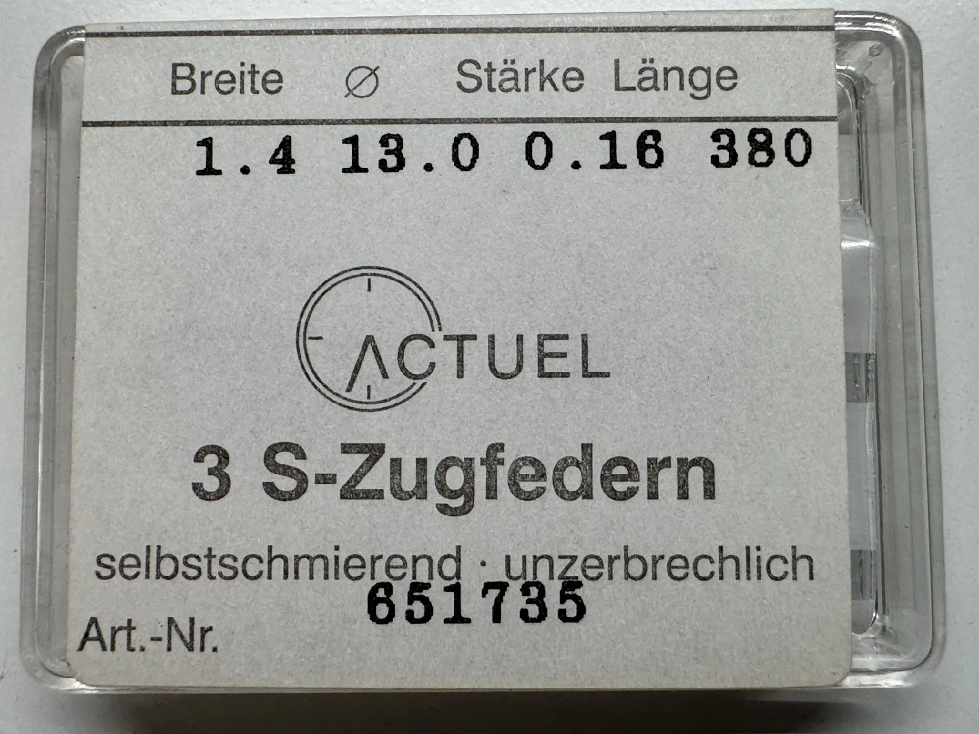 Zugfedern Set Set mit drei silberfarbenen Zugfedern für Uhren in transparenter Verpackung.