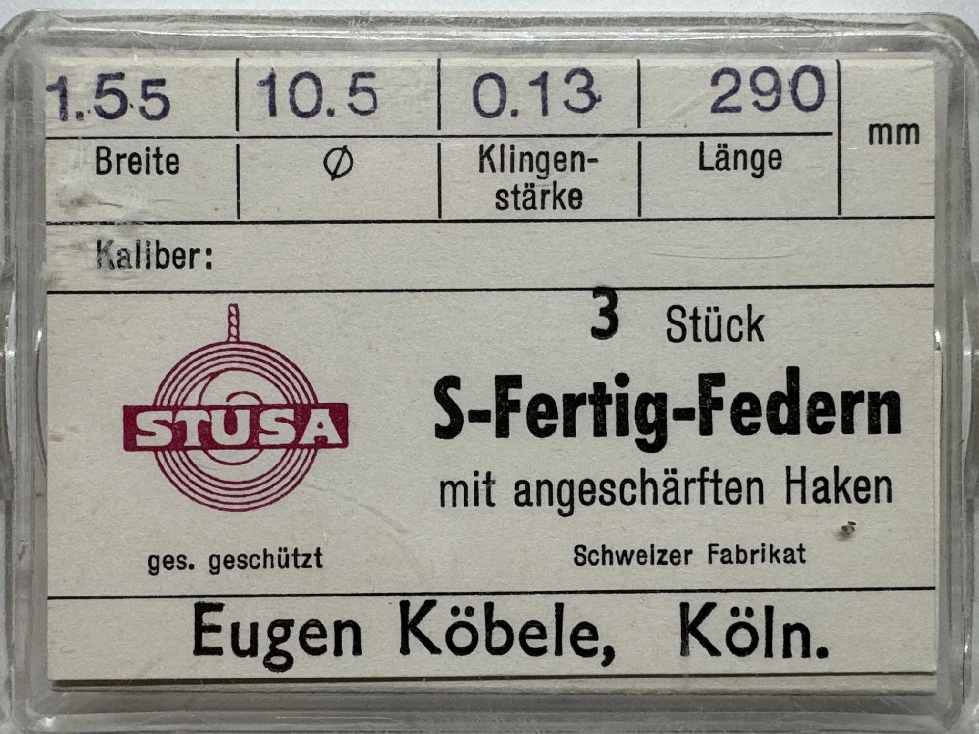 Set mit drei S-Fertig-Federn für Uhren mit angeschärften Haken in transparenter Verpackung.