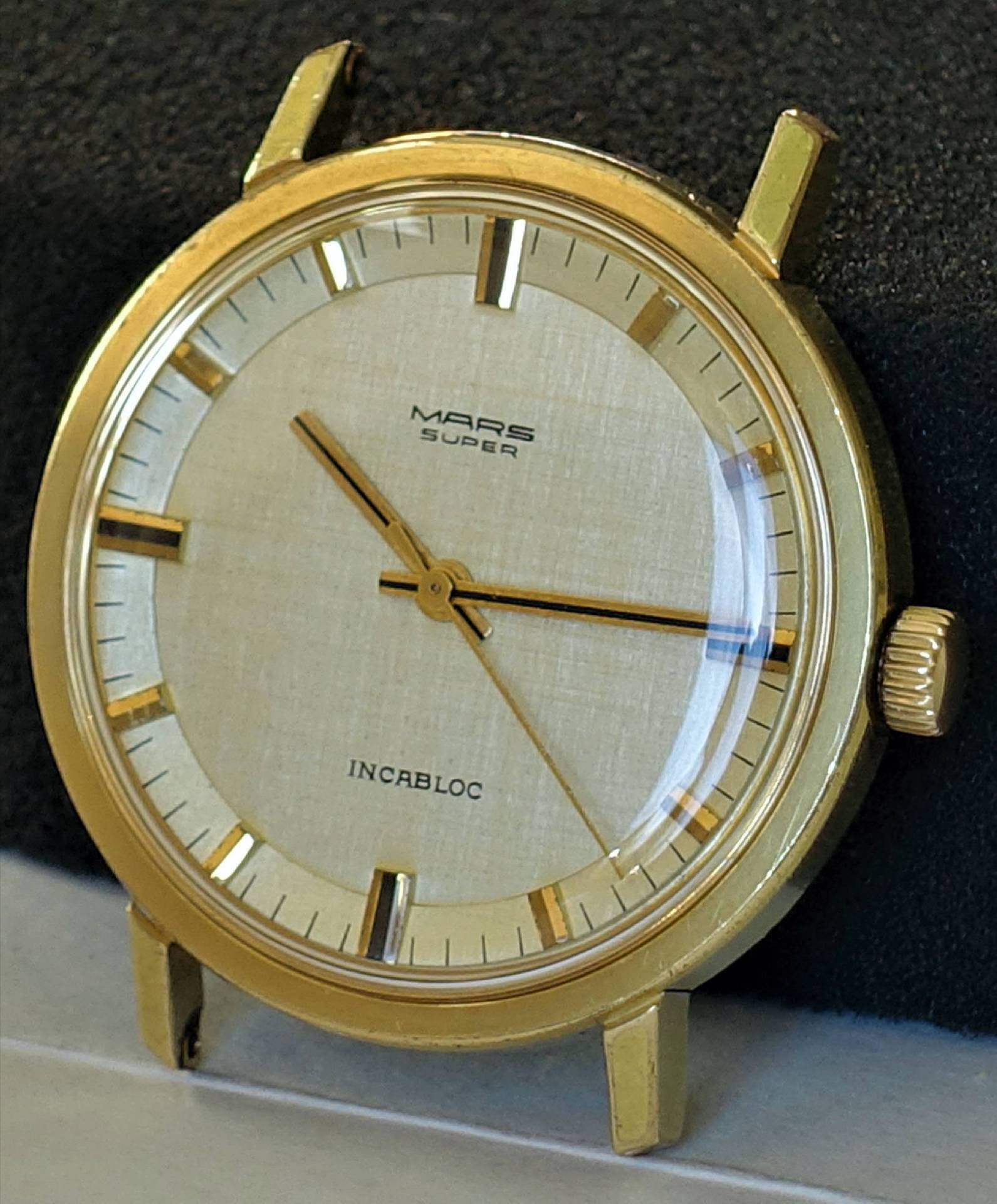 Goldfarbene Mars Super Armbanduhr mit hellem Zifferblatt und drei Zeigern.
