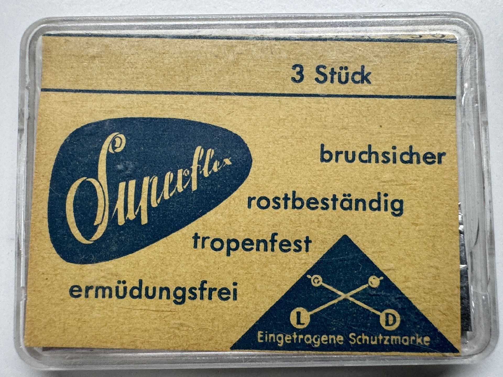 Verpackung mit drei Superflex Federstegen für Uhren, gelb-blaues Etikett mit Herstellerangaben.