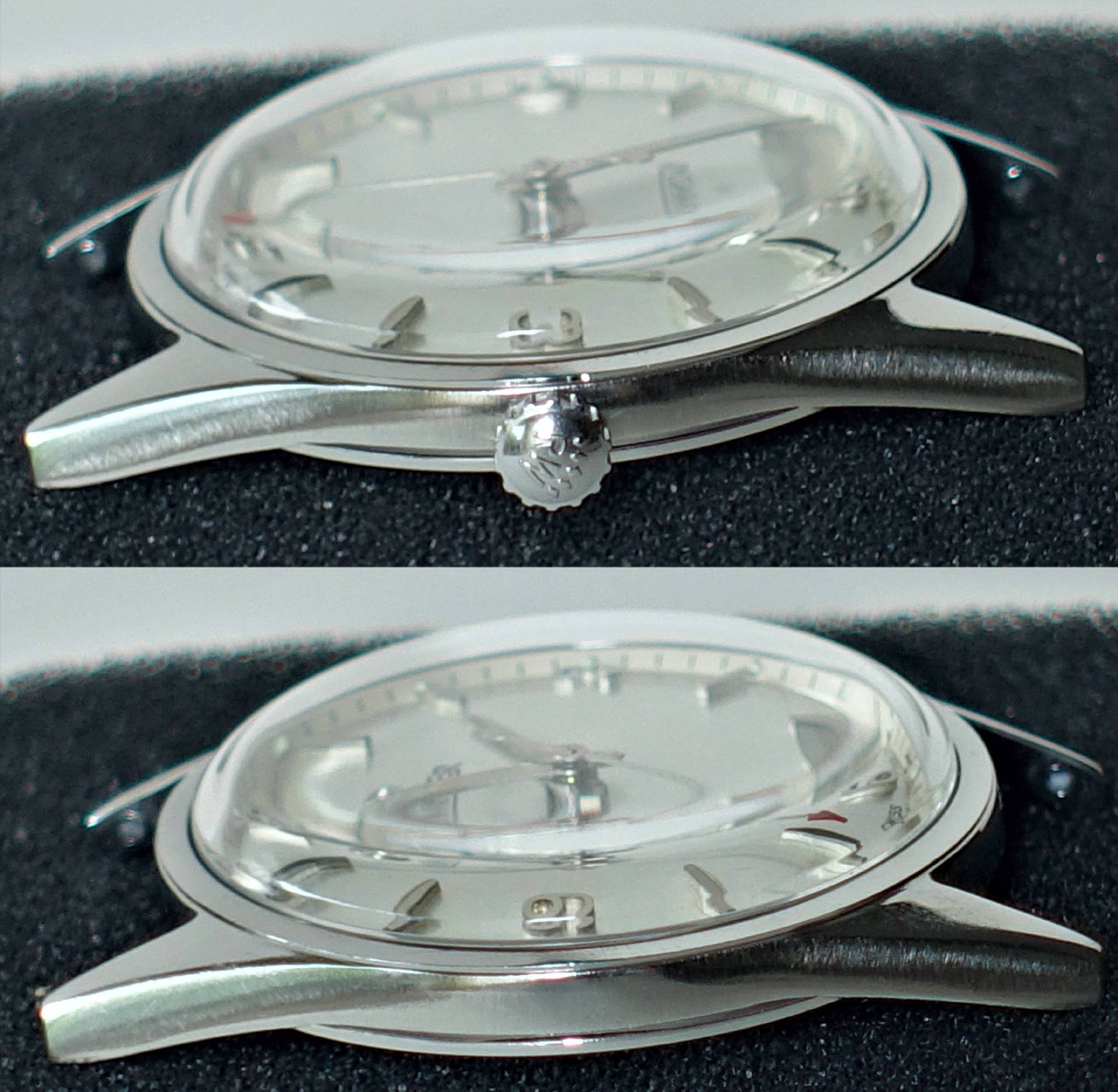 Silberfarbene Armbanduhr mit hellem Zifferblatt und gewölbtem Glas.
