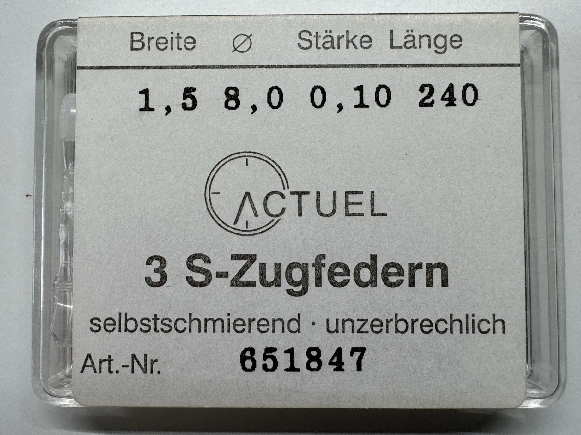 Zugfeder Set silberfarben Drei silberfarbene Zugfedern für Uhren in transparenter Verpackung.