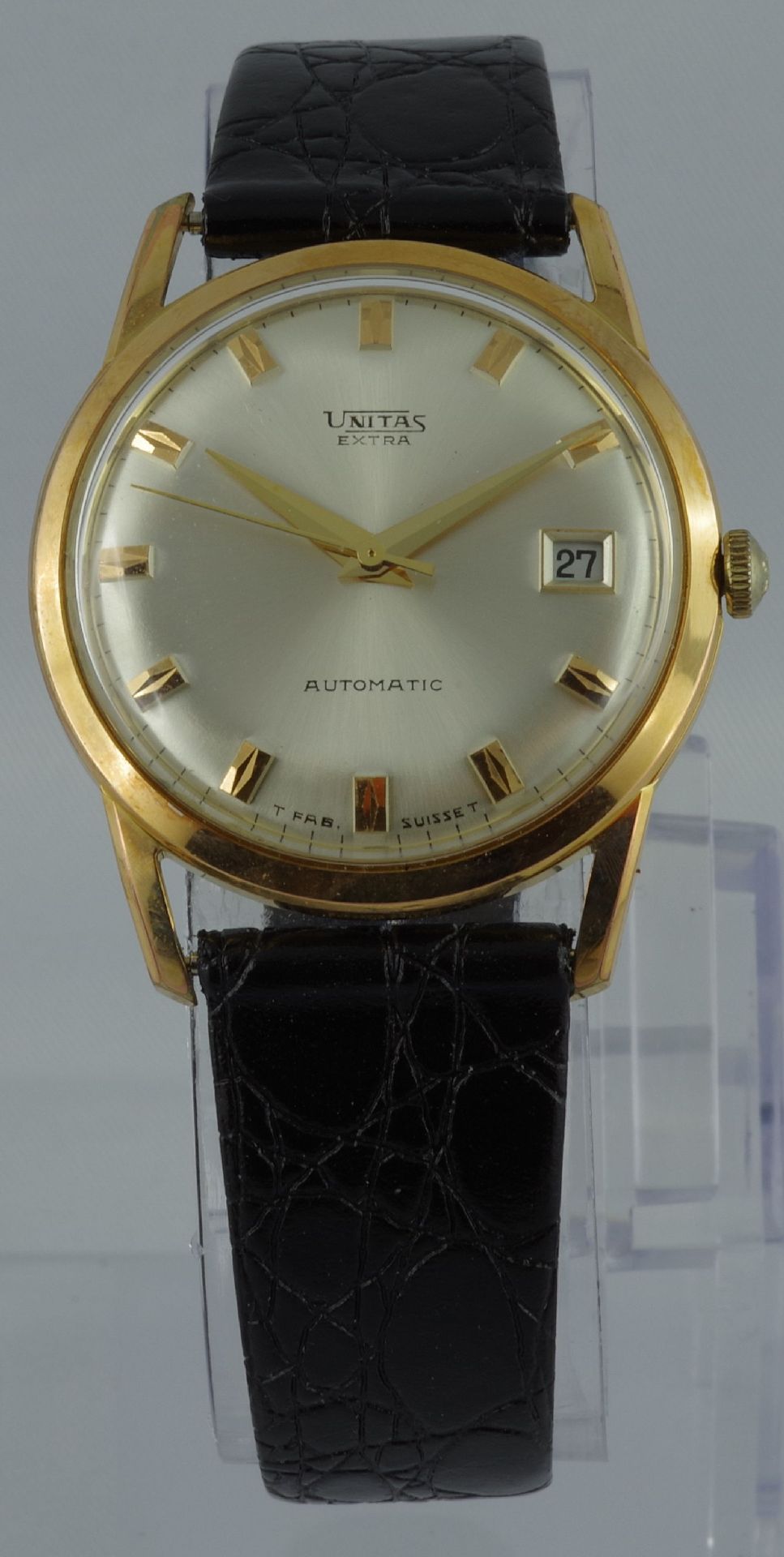 Goldfarbene Armbanduhr mit silbernem Zifferblatt, Datumsanzeige und schwarzem Lederarmband.