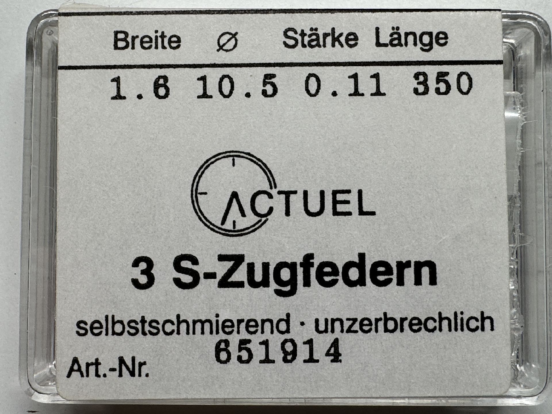 Verpackung mit drei Zugfedern für Uhren, beschriftet mit technischen Angaben.
