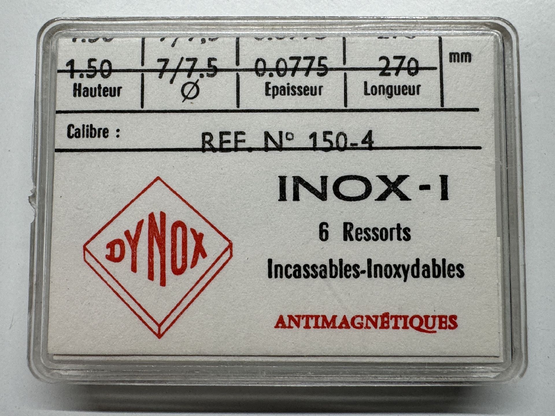 Verpackung mit sechs silberfarbenen Uhrfedern der Marke Dynox für Uhrwerke, antimagnetisch und bruchsicher.