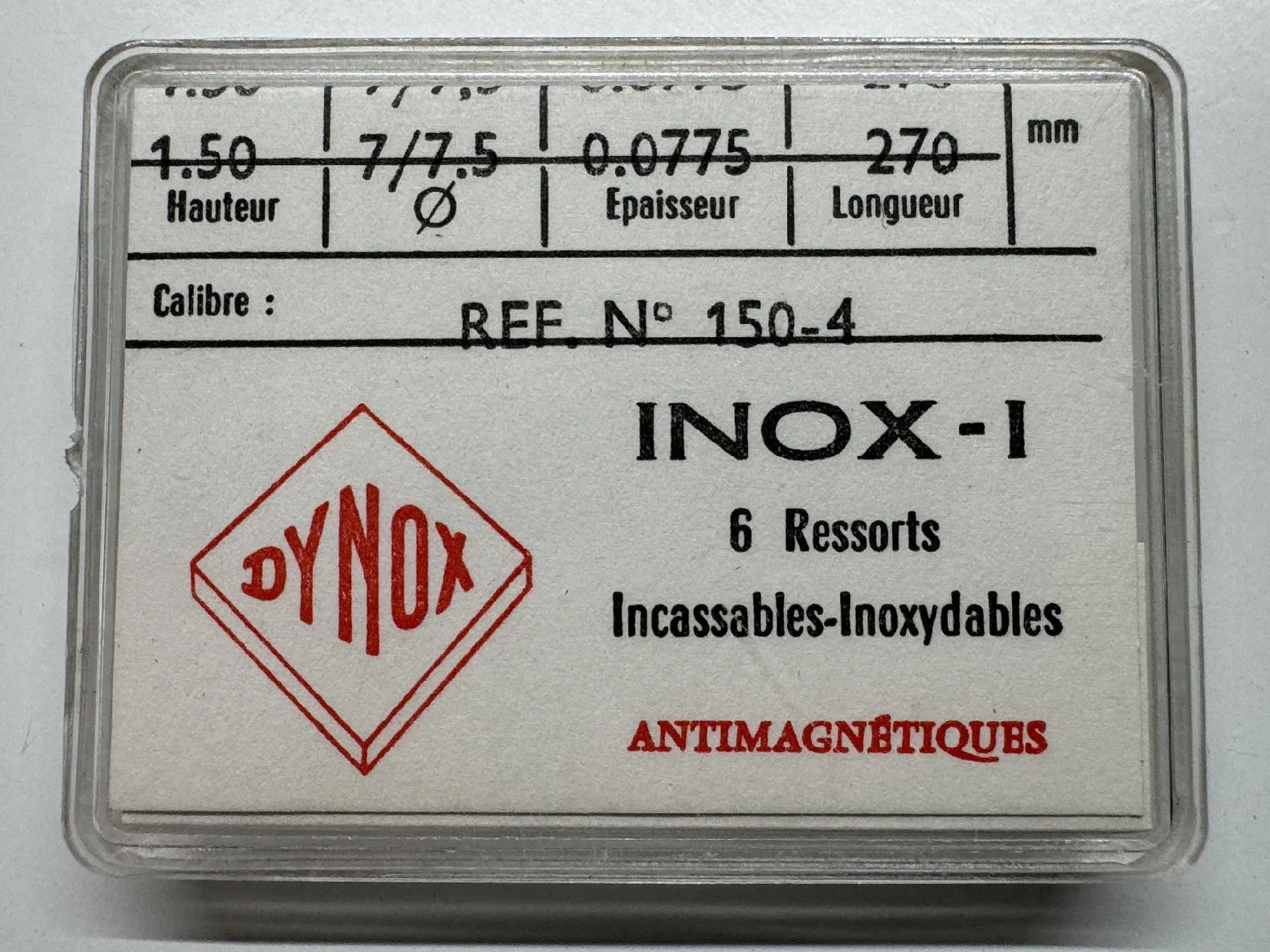 Dynox INOX-1 Uhrfedern Verpackung mit sechs silberfarbenen Uhrfedern der Marke Dynox für Uhrwerke, antimagnetisch und bruchsicher.